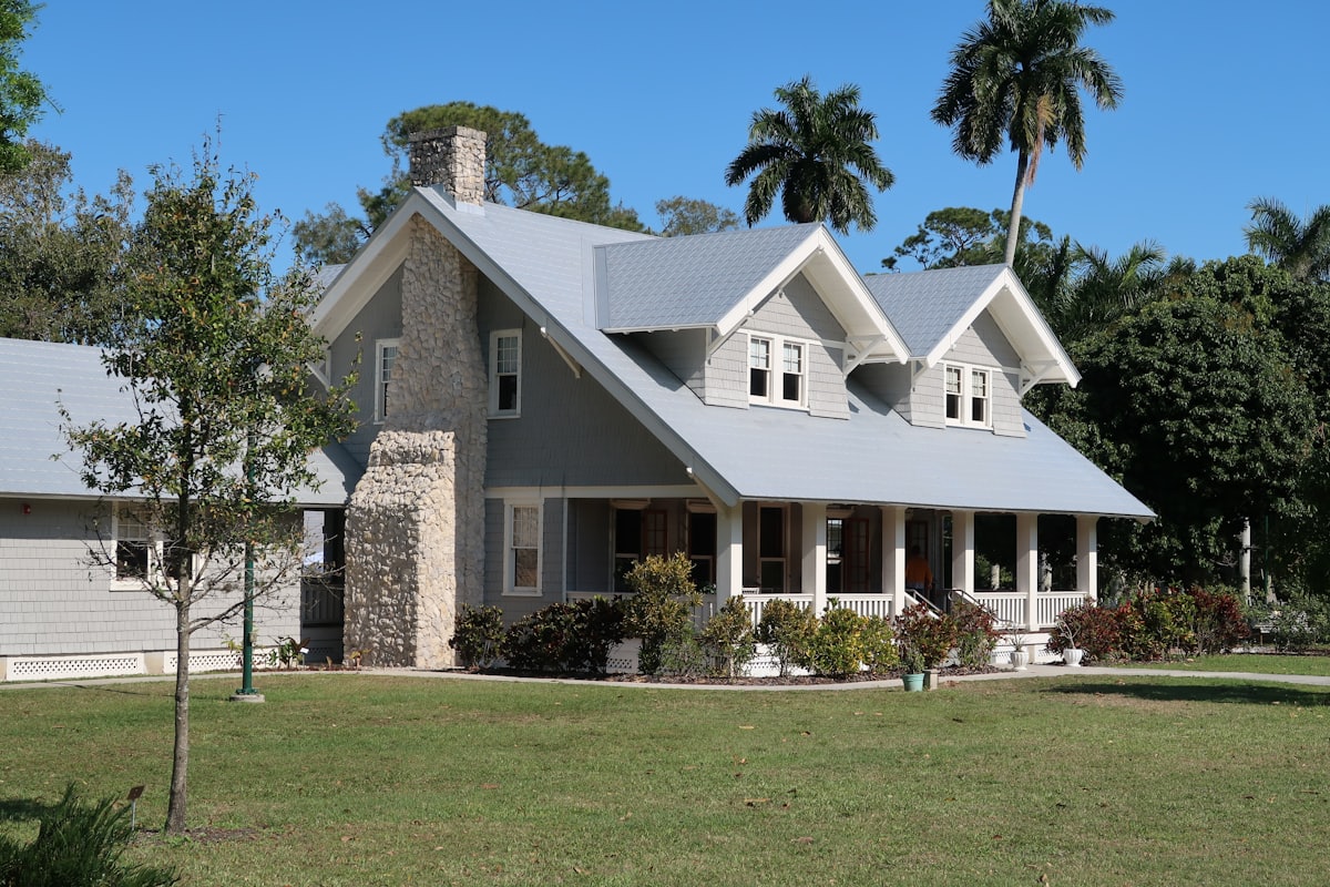 White two-story home with landscaped front yard